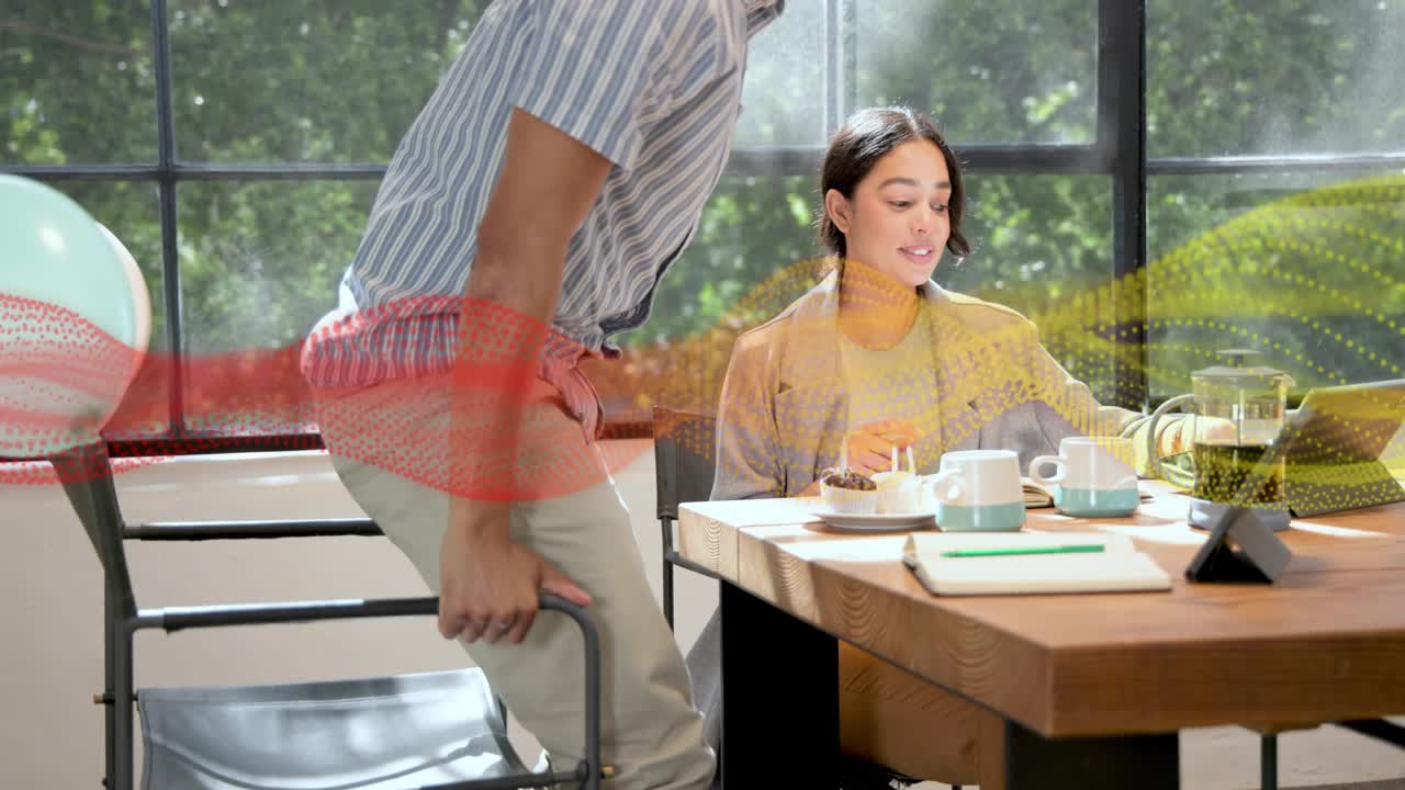 Colleagues marking birthday at work desk woman tapping phone sparking dots man clapping standing