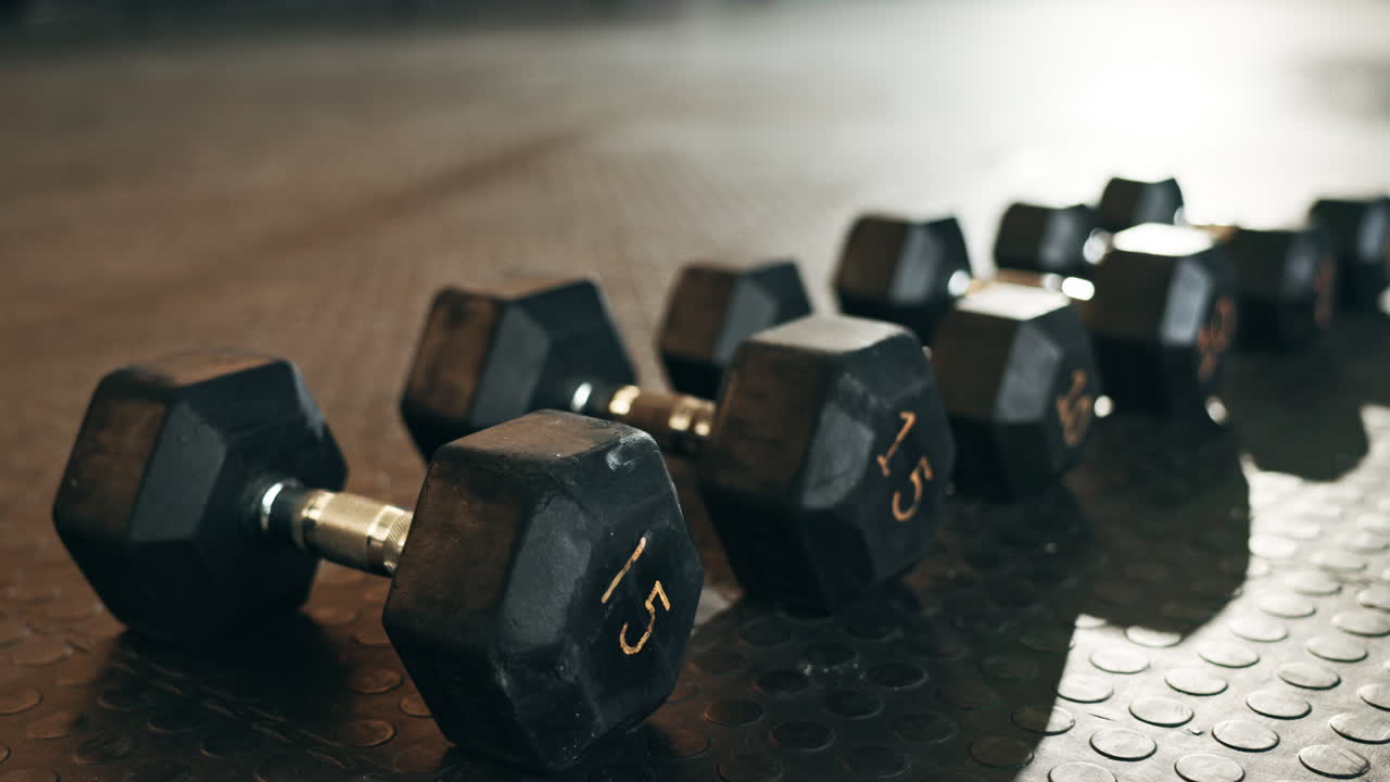 Fitness, background and dumbbells in empty gym