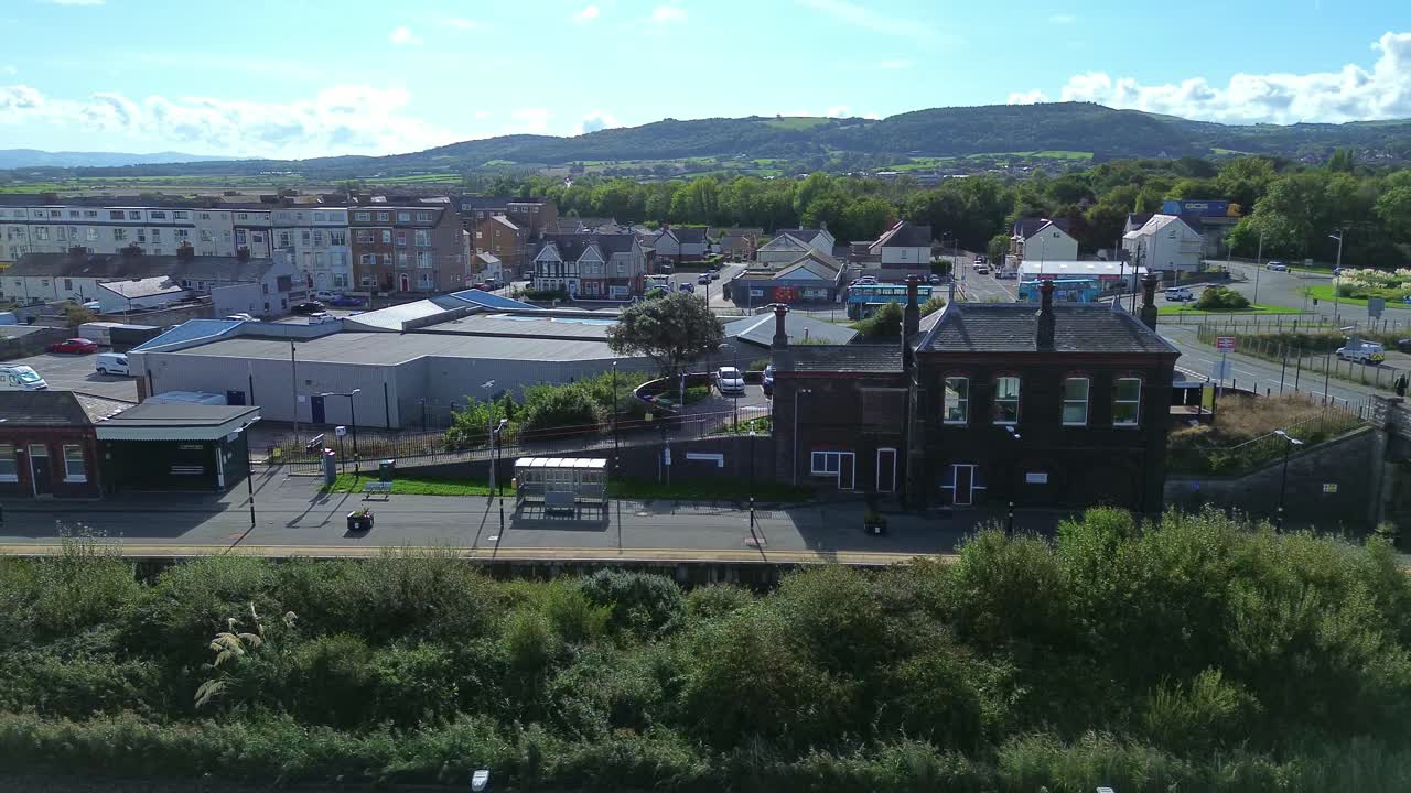 Pensarn townscape aerial view flying towards the railway station and sunny welsh coastal townscape