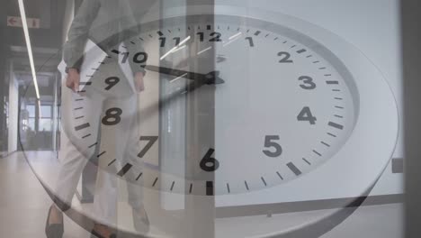 animation of ticking clock against low angle view of asian businesswoman walking at office