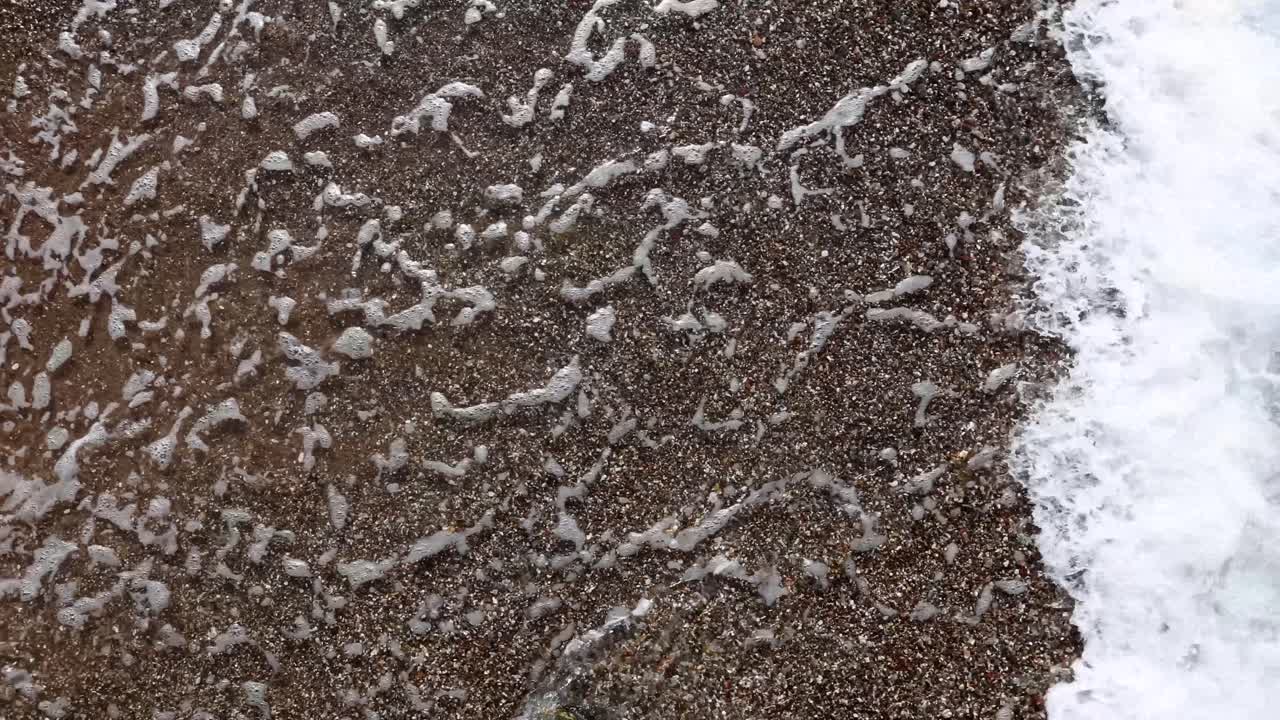 Waves crashing on a sandy beach