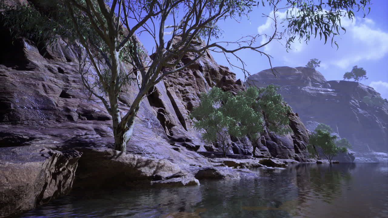 Serene riverbank surrounded by rocky mountains and lush greenery at sunset