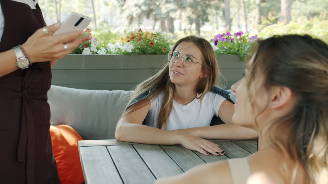 Waitress taking order at outdoor cafe