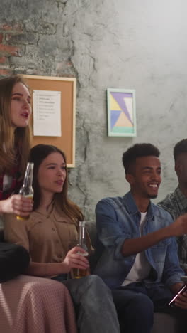 worried multinational group-mates watch football dramatic championship pointing to screen in living room slow motion. dangerous attack against favorite team gate