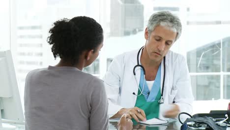 male doctor prescribing medicines to his patient