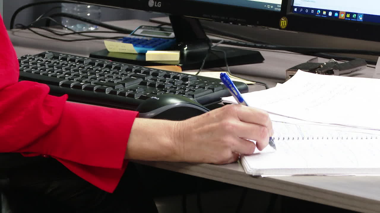 Woman taking notes at her desk