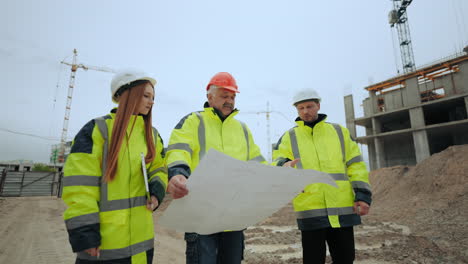 foreman architect and civil engineer are viewing construction site plan in modern building area