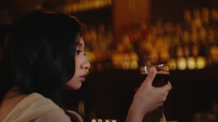 Woman with a glass of wine at a bar