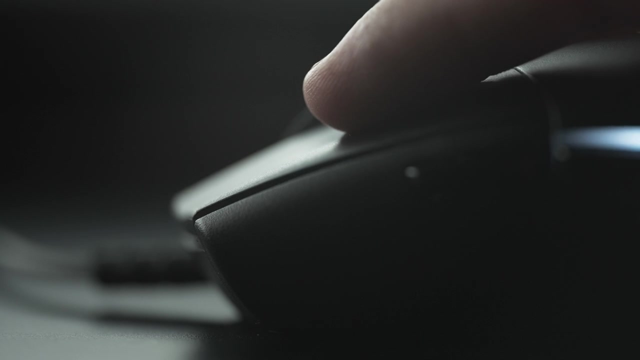 Clicking computer mouse on a work desk