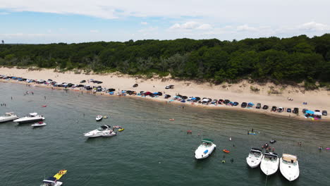 speedboats and vehicles in the beachfront of nickel beach in port colborne, ontario, canada- canal days marine heritage festival