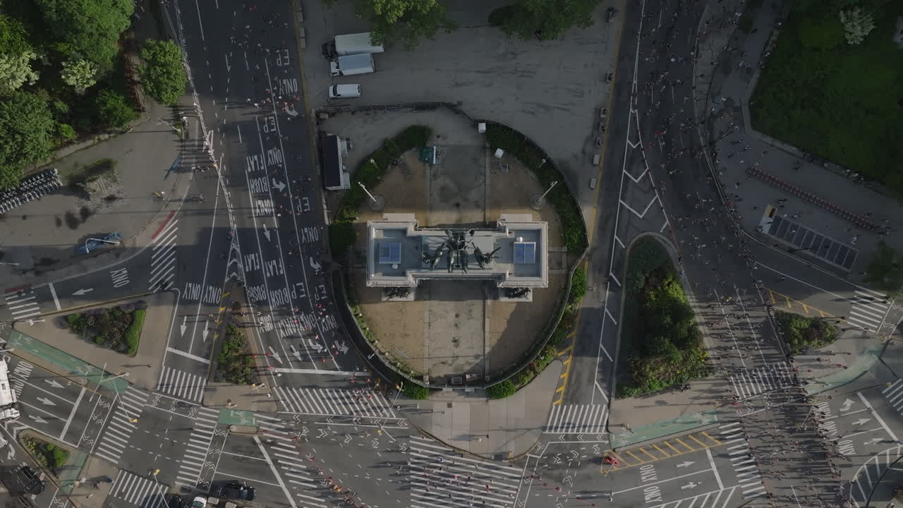Aerial view of people running the Brooklyn Half Marathon. Shot on a summer morning at Grand Army Plaza.