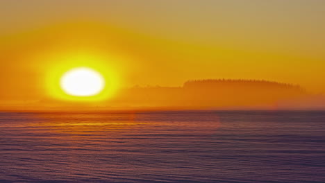 Time-lapse-of-vibrant-colored-setting-sun-over-snowy-landscape-at-sunset