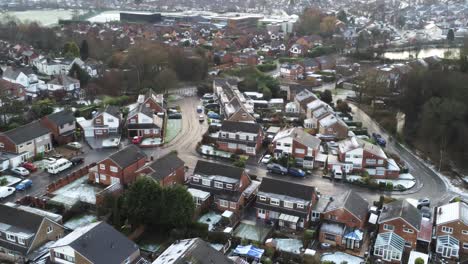 snowy aerial village residential neighbourhood winter frozen north west reverse over houses and roads