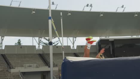 Side-view-of-caucasian-athlete-doing-high-jump