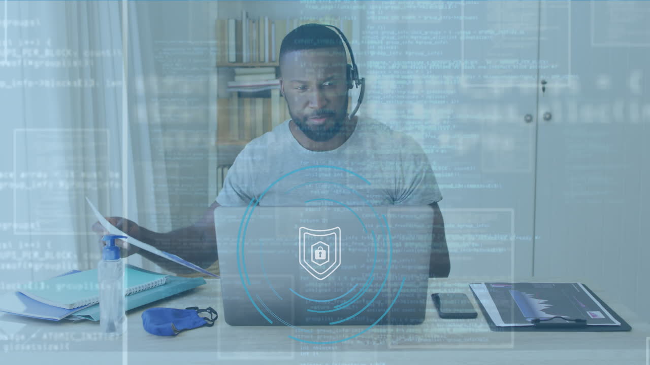 Animation of padlock and data processing over biracial businessman using laptop