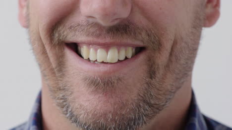 caucasian man mouth smiling happy teeth with unshaved facial hair stubble cheerful expression close up white background