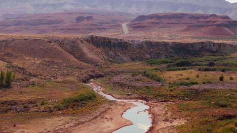 desert canyon landscape with riverbed and road