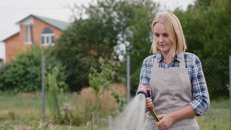 a woman watering plants in her garden