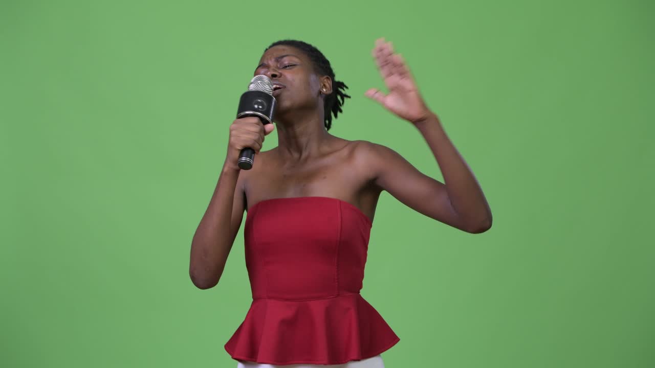 Young beautiful African woman using microphone