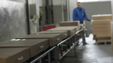 post warehouse. parcels move along a conveyor belt in the post-sorting department. loading belt, postal worker prepares parcels for shipment. online order delivery.