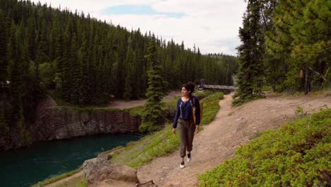 indian woman walks along the miles canyon nature trail, long shot