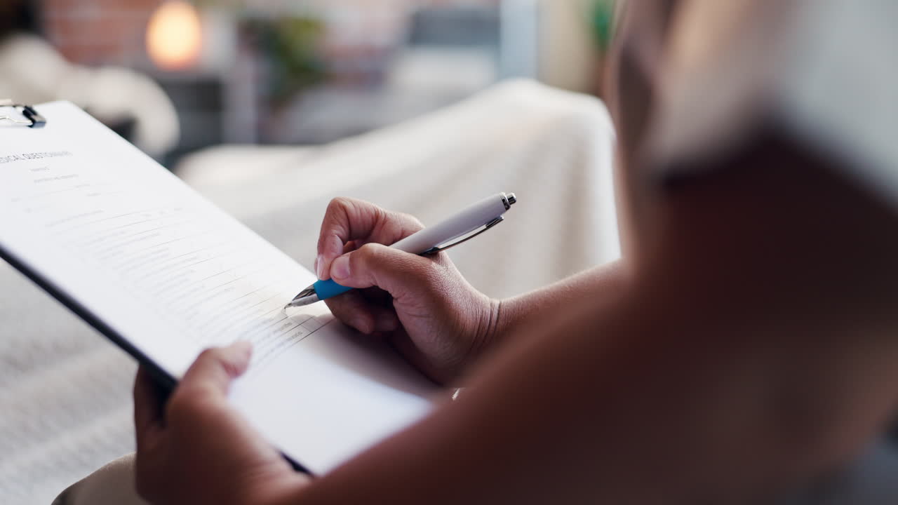 Close-Up of Person's Hands Filling Out a Medical Questionnaire