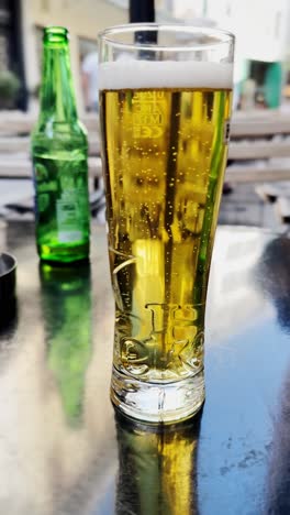 refreshing glass of cold beer on an outdoor cafe table in athens