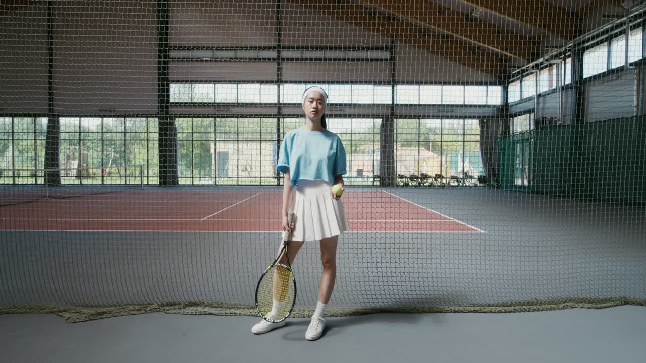 Woman playing tennis in an indoor court