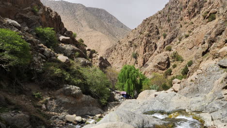 stream running through lush rugged atlas mountain valley landscape, morocco