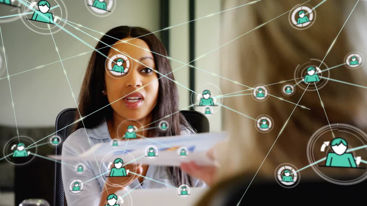 Animation of network of connections with icons over diverse colleagues discussing work in office