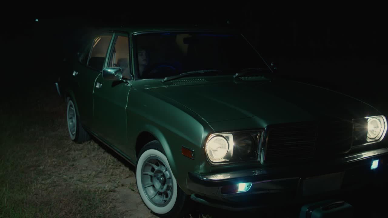 Vintage Green Car at Night