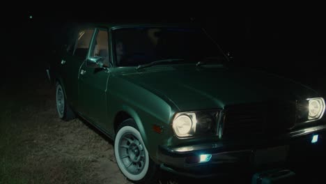 vintage green car at night