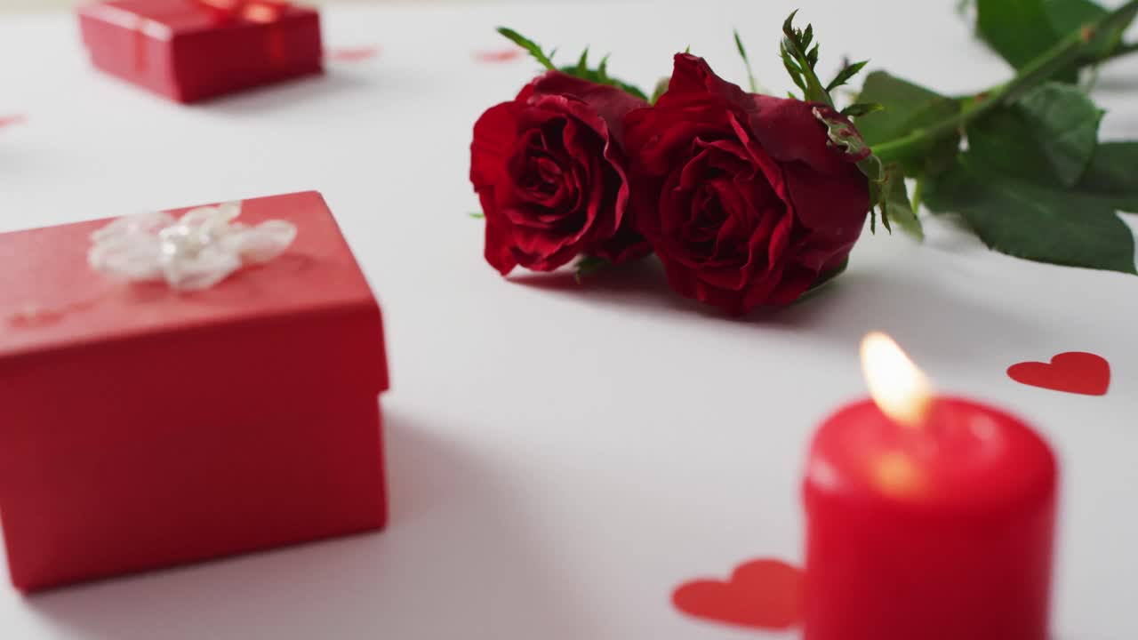 Red roses and gifts on white background at valentine's day