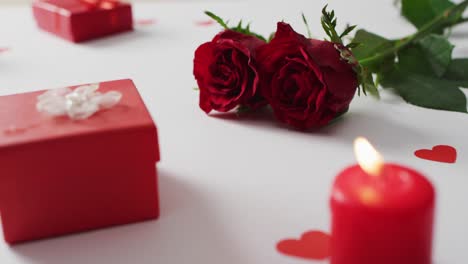 red roses and gifts on white background at valentine's day