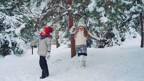 child at winter in nature. happy kids playing together with snow, outdoors winter vacation