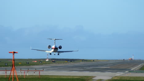 regional aircraft landing on the sunny runway, long shot, static