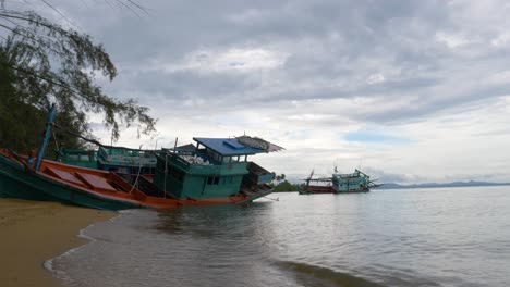 old wooden fishing boat stranded on the beach