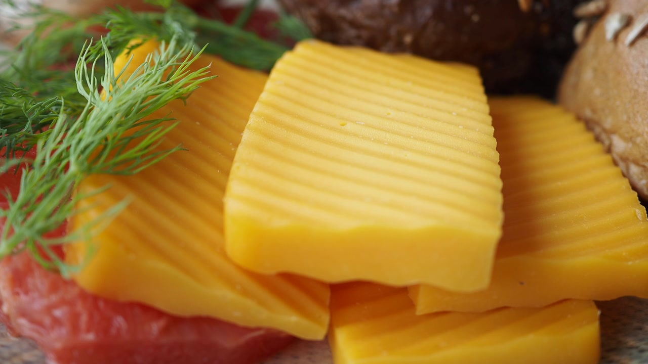 Delicious Yellow Cheese Slices with Bread and Fresh Dill