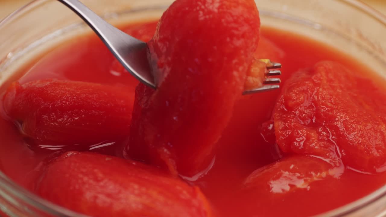 Peeled tomatoes texture, fresh canned tomato Juice sauce, bowl with peeled tomatoes in their own juice, Top view close up, Italian traditional cuisine food.
