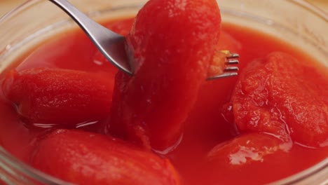 peeled tomatoes texture, fresh canned tomato juice sauce, bowl with peeled tomatoes in their own juice, top view close up, italian traditional cuisine food.