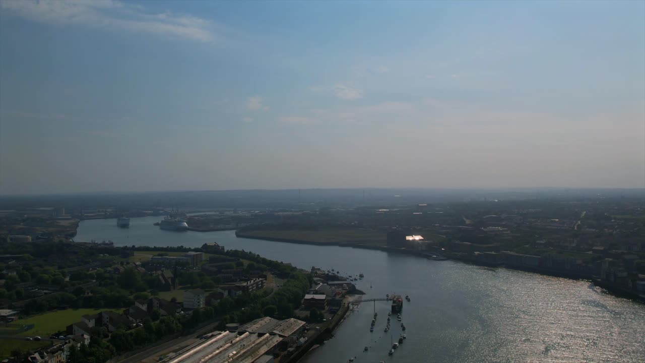 크루즈 선박과 어두운 하늘 아래의 광활한 도시 풍경을 특징으로하는 타인 강의 드론 영상