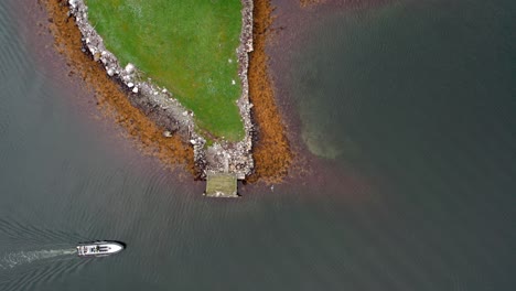 Boat-driving-on-the-coast-of-half-island-in-Norway-drone-shot