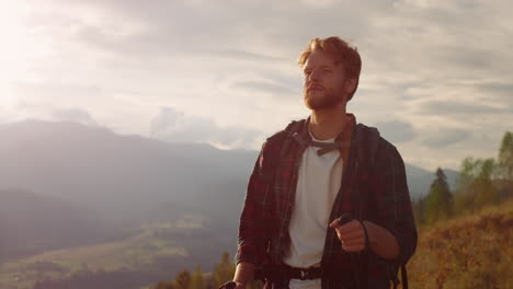 Closeup-confident-man-hiking-mountains.-Relaxed-tourist-travel-on-summer-holiday