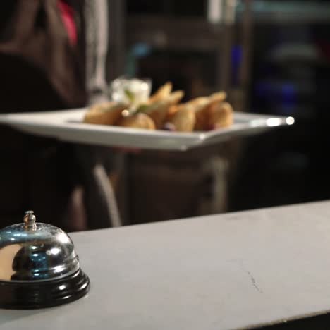 waiter serving dessert at restaurant