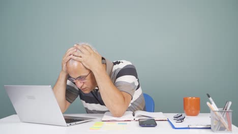 man looking at laptop gets frustrated.