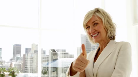 happy businesswoman giving thumbs up