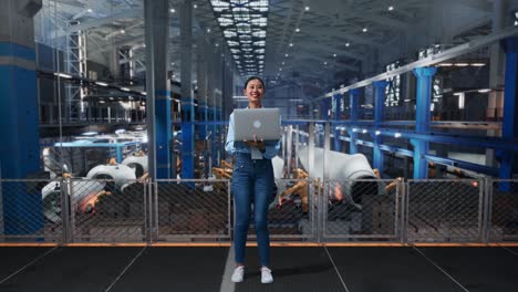 woman engineer using laptop in factory