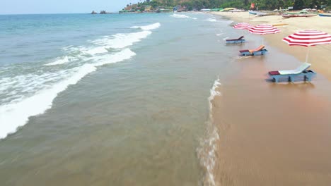 arambol-goa-beach-drone-shot-ships-boats-on-empty-beach-birds-eye-view-beach-shacks-beach-bed-summer-vacation