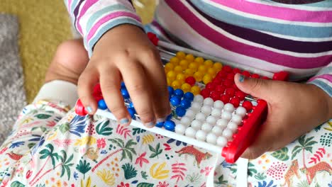 toddler playing with counting math learning toy