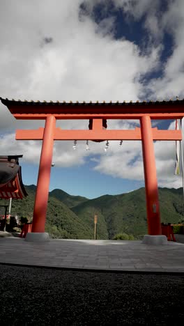 red torii gate marking the entrance to the kumano nachi taisha shrine, a sacred shinto site nestled in the mountains of japan. vertical video